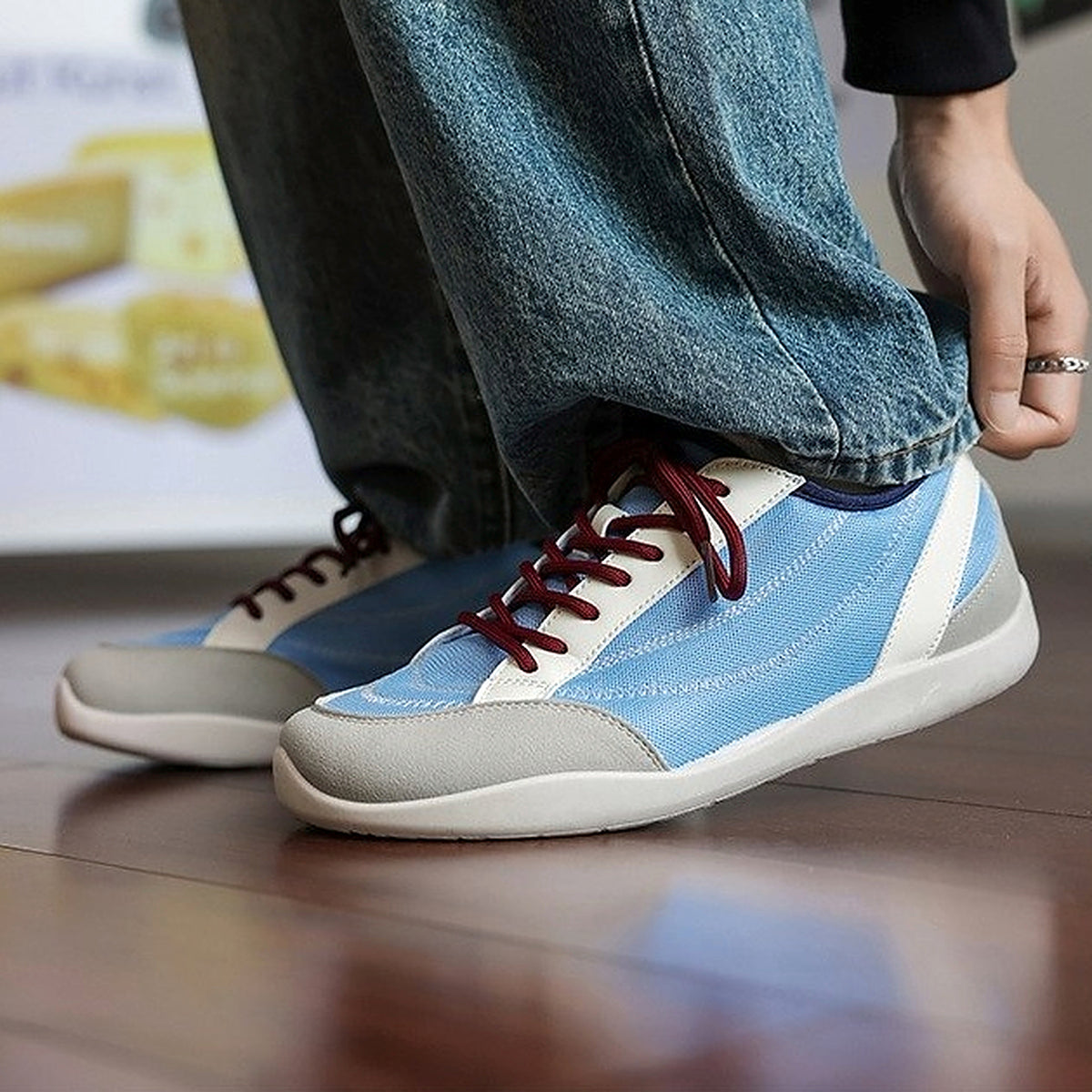 SNK AeroStitch Trainer Sky Blue on feet, crouched streetwear look