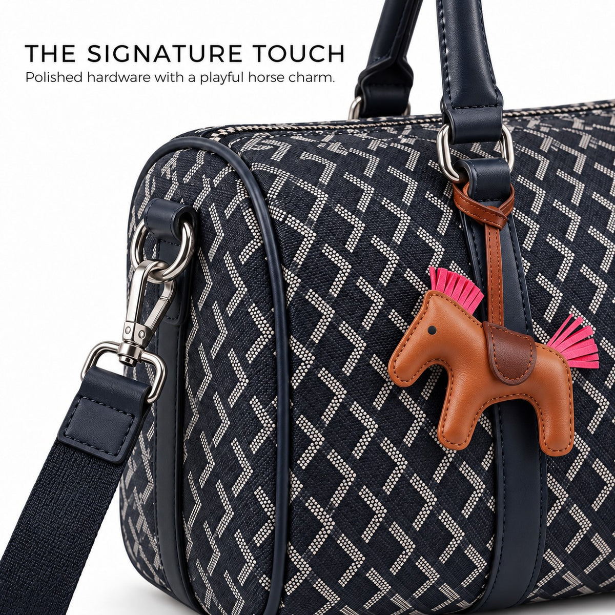 Close-up of metal snap hook and brown horse charm on the navy truffle bag